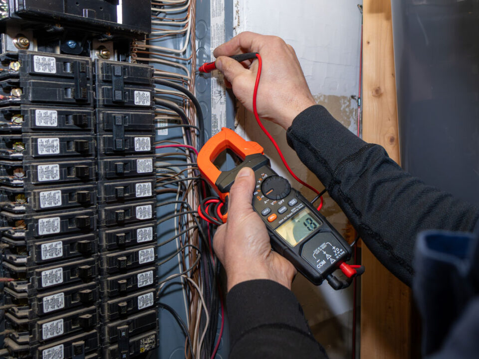 Home inspector testing home circuit breaker